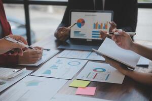 Finance manager meeting discussing company growth project success financial statistics, professional investor working start up project for strategy plan with document, laptop and digital tablet. photo