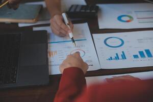 Finance manager meeting discussing company growth project success financial statistics, professional investor working start up project for strategy plan with document, laptop and digital tablet. photo