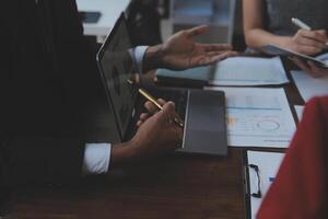Finance manager meeting discussing company growth project success financial statistics, professional investor working start up project for strategy plan with document, laptop and digital tablet. photo