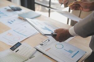 Finance manager meeting discussing company growth project success financial statistics, professional investor working start up project for strategy plan with document, laptop and digital tablet. photo