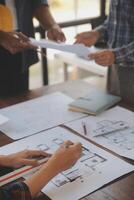 A team of construction engineers talks to managers and construction workers at the construction site. Quality inspection, work plan, home and industrial building design project photo