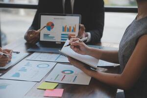 Finance manager meeting discussing company growth project success financial statistics, professional investor working start up project for strategy plan with document, laptop and digital tablet. photo