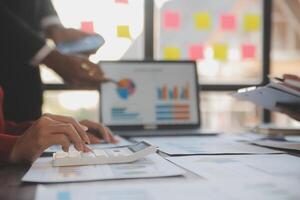 Finance manager meeting discussing company growth project success financial statistics, professional investor working start up project for strategy plan with document, laptop and digital tablet. photo