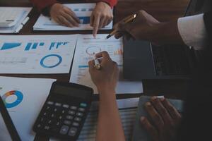 Finance manager meeting discussing company growth project success financial statistics, professional investor working start up project for strategy plan with document, laptop and digital tablet. photo