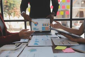 Finance manager meeting discussing company growth project success financial statistics, professional investor working start up project for strategy plan with document, laptop and digital tablet. photo