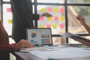 Finance manager meeting discussing company growth project success financial statistics, professional investor working start up project for strategy plan with document, laptop and digital tablet. photo