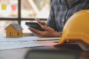 A team of construction engineers talks to managers and construction workers at the construction site. Quality inspection, work plan, home and industrial building design project photo