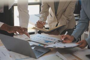 Finance manager meeting discussing company growth project success financial statistics, professional investor working start up project for strategy plan with document, laptop and digital tablet. photo