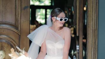 Joyful Bride Dancing in Doorway, A happy bride dances in a doorway, her movements full of excitement and joy. video