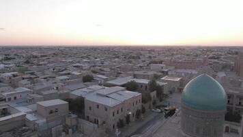 Po-i-Kalyan mosque complex in Bukhara and Kalyan Minaret at sunset, drone aerial video