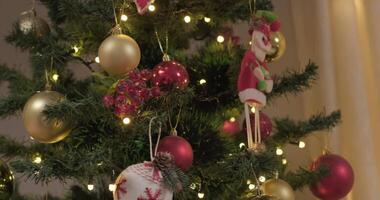 Toy Santa and balls hanging on christmas tree video