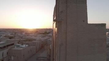 Portal of mosque in the rays of the setting sun, drone aerial video