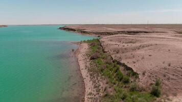 Blue lake in the middle of desert, drone aerial video