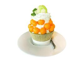 isolated Melon Shaved Ice or Bingsu on a white background is a Korean style shaved ice menu. It is popular to eat garnished with cut fruit, syrup, and sweetened condensed milk. photo