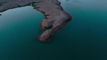 Blue lake in the middle of desert, drone aerial video