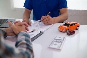 Car dealers recommend car to customers before entering into sales contracts so that customers can get the car they like before paying contract money. Concept of making sales contract with distributor photo