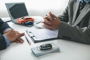 Car dealers recommend car to customers before entering into sales contracts so that customers can get the car they like before paying contract money. Concept of making sales contract with distributor photo