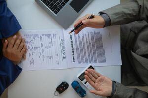 Car dealers recommend car to customers before entering into sales contracts so that customers can get the car they like before paying contract money. Concept of making sales contract with distributor photo