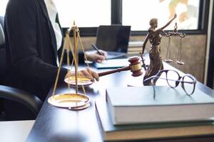 judge holds givel wood tapped on the wooden base to read verdict for victims and defendants to know the verdict obtained from the evidence and the lawyer's defense of the case. court decision concept photo