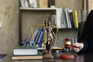 judge holds givel wood tapped on the wooden base to read verdict for victims and defendants to know the verdict obtained from the evidence and the lawyer's defense of the case. court decision concept photo