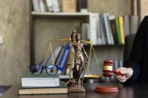 judge holds givel wood tapped on the wooden base to read verdict for victims and defendants to know the verdict obtained from the evidence and the lawyer's defense of the case. court decision concept photo