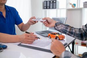 Car dealers recommend car to customers before entering into sales contracts so that customers can get the car they like before paying contract money. Concept of making sales contract with distributor photo