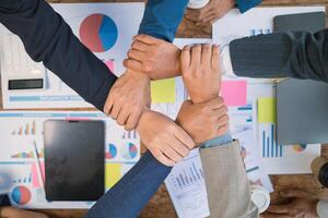 Businessmen and investors shake hands as symbol of joint venture after discussing, consulting and making contract to invest in business together. business people shaking hands as symbol of cooperation photo