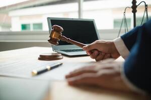 judge holds givel wood tapped on the wooden base to read verdict for victims and defendants to know the verdict obtained from the evidence and the lawyer's defense of the case. court decision concept photo