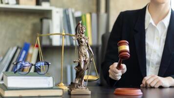 judge holds givel wood tapped on the wooden base to read verdict for victims and defendants to know the verdict obtained from the evidence and the lawyer's defense of the case. court decision concept photo