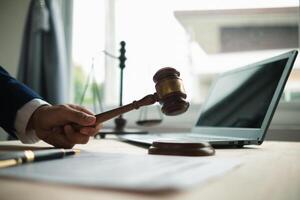 judge holds givel wood tapped on the wooden base to read verdict for victims and defendants to know the verdict obtained from the evidence and the lawyer's defense of the case. court decision concept photo