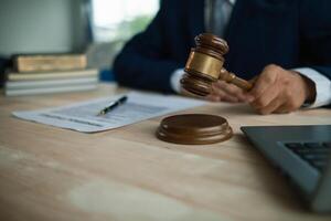 judge holds givel wood tapped on the wooden base to read verdict for victims and defendants to know the verdict obtained from the evidence and the lawyer's defense of the case. court decision concept photo