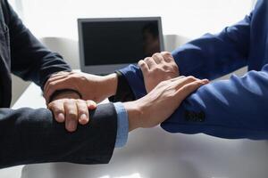 Businessmen and investors shake hands as symbol of joint venture after discussing, consulting and making contract to invest in business together. business people shaking hands as symbol of cooperation photo