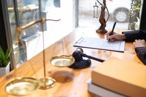 contract was placed on table inside legal counsel's office, ready for investors to sign the contract to hire a team of lawyers to provide legal advice for their investment. legal consulting concept photo