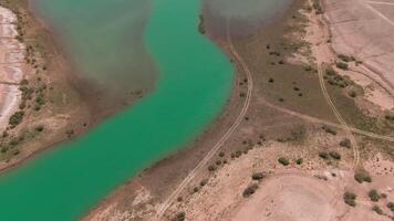 Blue lake in the middle of desert, drone aerial video