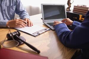 contract was placed on table inside legal counsel's office, ready for investors to sign the contract to hire a team of lawyers to provide legal advice for their investment. legal consulting concept photo