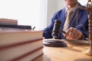 judge holds givel wood tapped on the wooden base to read verdict for victims and defendants to know the verdict obtained from the evidence and the lawyer's defense of the case. court decision concept photo