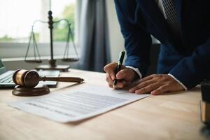 contract was placed on table inside legal counsel's office, ready for investors to sign the contract to hire a team of lawyers to provide legal advice for their investment. legal consulting concept photo