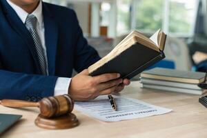 young lawyer was flipping through Bible in his legal office just to learn about God teachings from the Bible and to be reminded to do what is right. The concept of belief and the power of faith in God photo