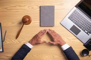 lawyer used his hands together as sign to pray to God based on his faith and power of faith in God and to pray that he would be able to win case based on the evidence and information gathered. photo