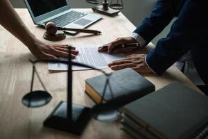 contract was placed on table inside legal counsel's office, ready for investors to sign the contract to hire a team of lawyers to provide legal advice for their investment. legal consulting concept photo