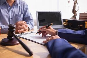 contract was placed on table inside legal counsel's office, ready for investors to sign the contract to hire a team of lawyers to provide legal advice for their investment. legal consulting concept photo