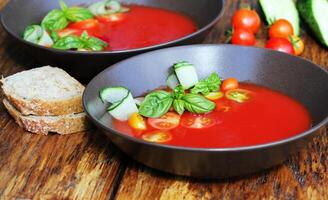 Homemade Gazpacho tomato soup in brown bowl. Healthy eating concept photo