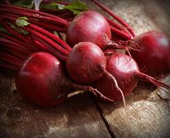 Fresh beetroot on rustic wooden background. Harvest vegetable cooking conception . Diet or vegetarian food concept photo