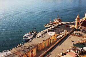 Panoramic skyline view of ancient defences of Valletta and the Grand Harbor with ships photo