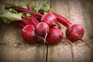 Fresh beetroot i on rustic wooden background. Harvest vegetable cooking conception . Diet or vegetarian food concept photo