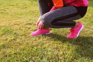 Runner athlete preparing to run the outdoor. Fitness woman training and jogging in summer park photo