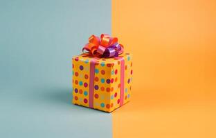 AI generated Present wrapped in yellow paper with colorful polka dot pattern. Pink ribbon and colorful bow on top of gift box. Happy Birthday concept. Blue and yellow background with copy space. photo