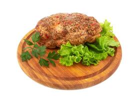 Baked meat on cutting board photo