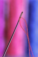 Close-up view of one needle with red thread photo