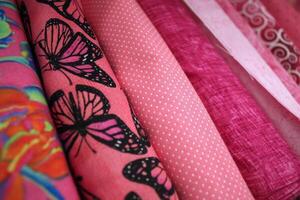 Vibrantly Colored Bolts of Pink Printed Fabric photo